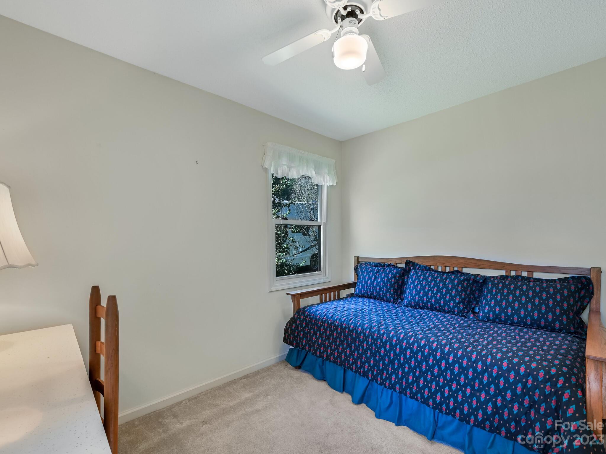 15 Maple Road Arden, NC 28704 - Photo 21 of 33 a blue bed sitting in a bedroom next to a window