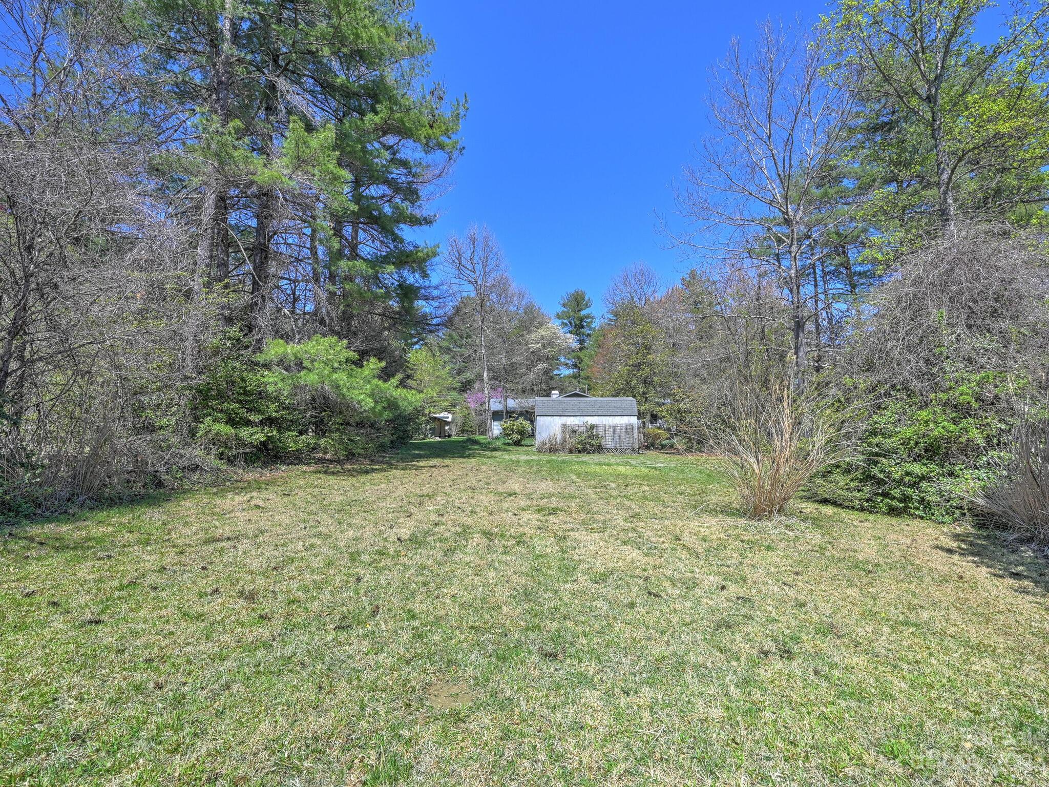 15 Maple Road Arden, NC 28704 - Photo 29 of 33 a backyard of a house with table and chairs