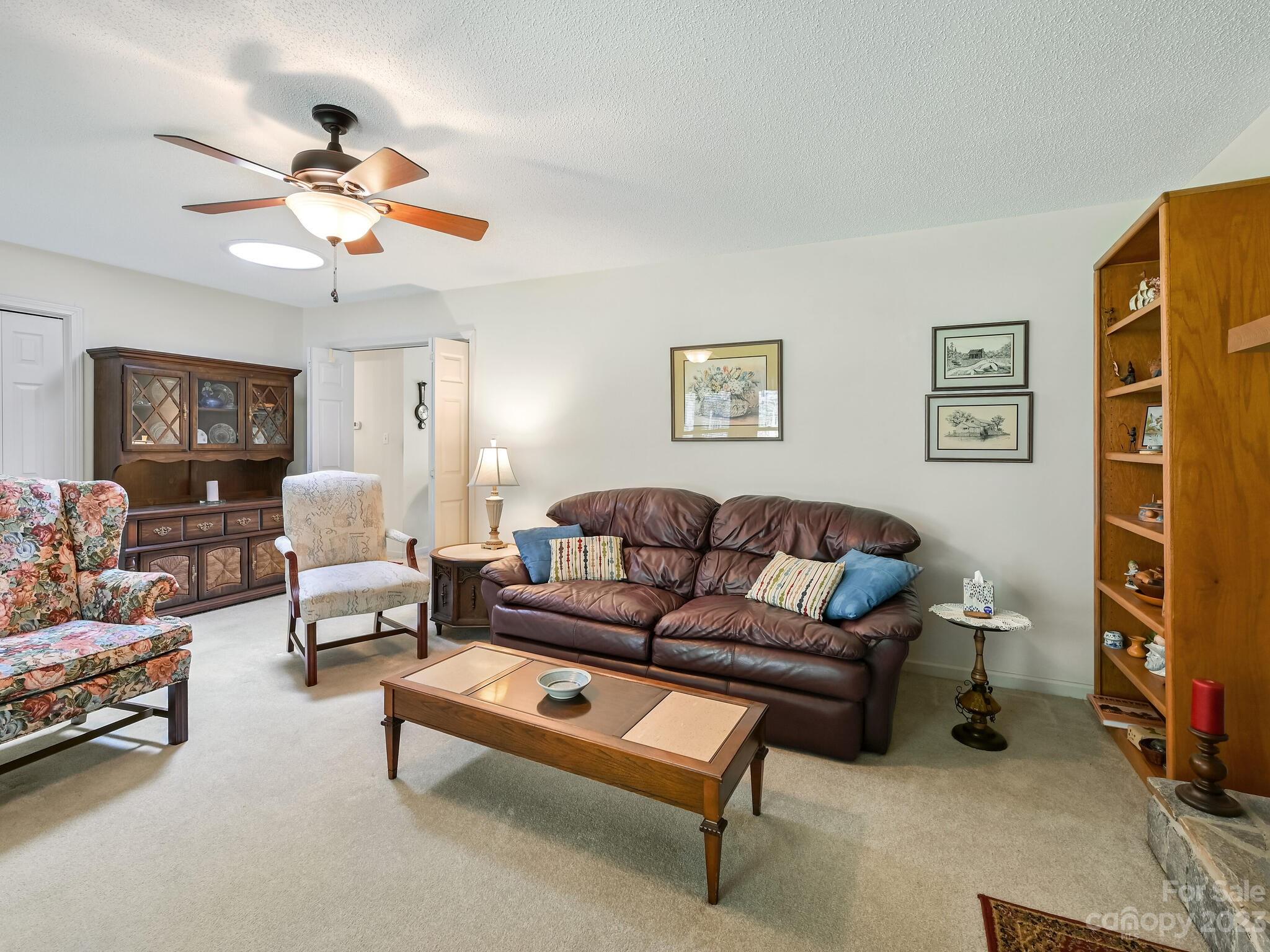 15 Maple Road Arden, NC 28704 - Photo 5 of 33 a living room with furniture a couch and a bookshelf