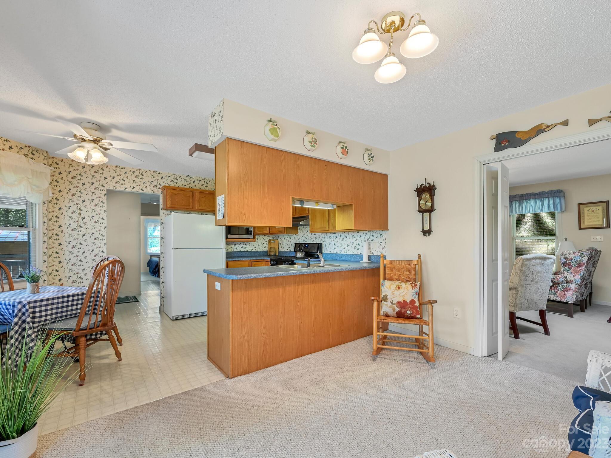 15 Maple Road Arden, NC 28704 - Photo 8 of 33 a living room with furniture a chandelier and a dining table