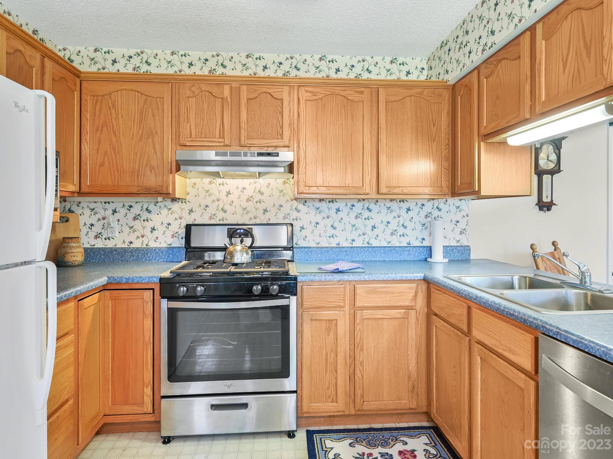 15 Maple Road Arden, NC 28704 - Photo 10 of 33 a kitchen with granite countertop a stove sink and cabinets