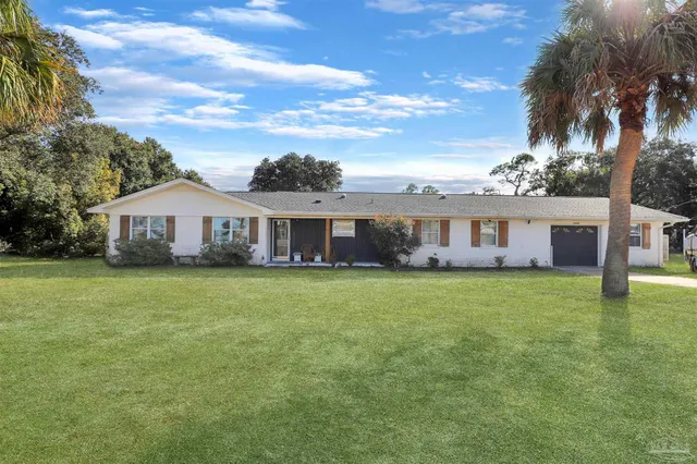 a front view of a house with a garden