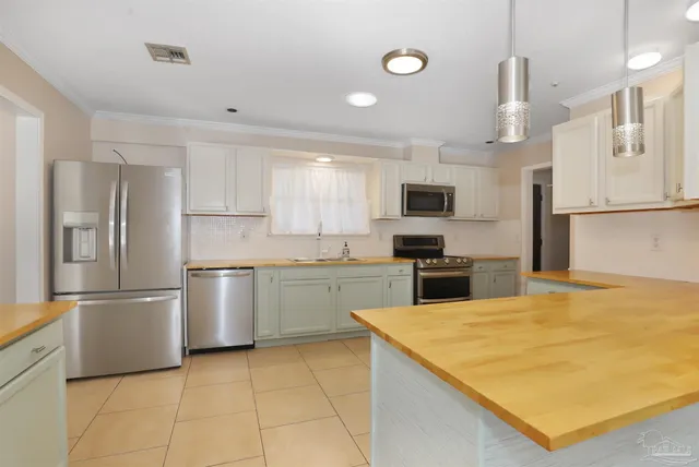 a kitchen with stainless steel appliances a refrigerator sink and microwave