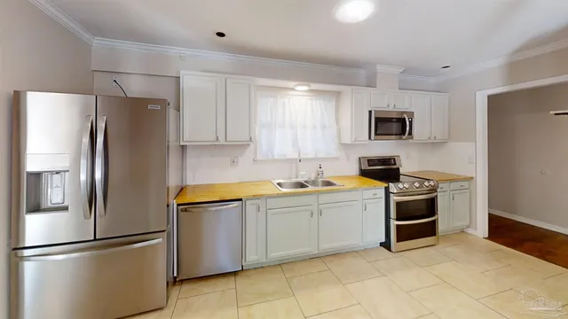 a kitchen with stainless steel appliances granite countertop a refrigerator sink and stove