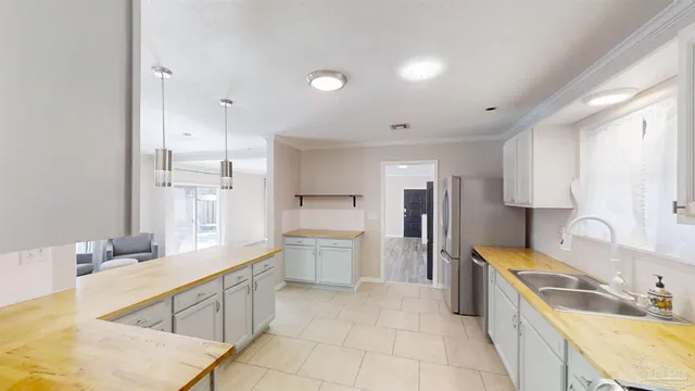 a large kitchen with a large window and stainless steel appliances