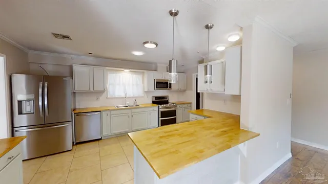 a kitchen with stainless steel appliances granite countertop a refrigerator oven a sink dishwasher and a refrigerator