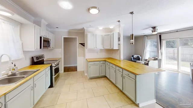 a large kitchen with stainless steel appliances kitchen island granite countertop a sink and cabinets