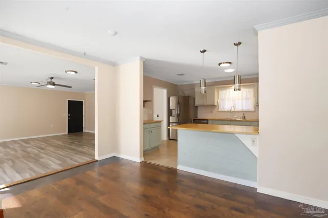 a view of a kitchen with wooden floor and a sink