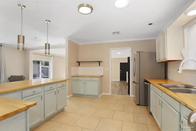 a kitchen with a sink and refrigerator