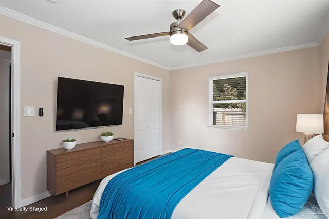 a bedroom with a bed and a flat screen tv