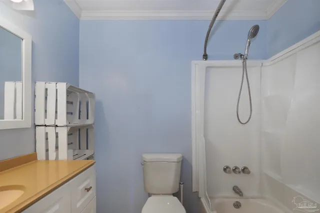 a bathroom with a toilet sink and shower