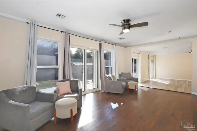 a living room with furniture and wooden floor