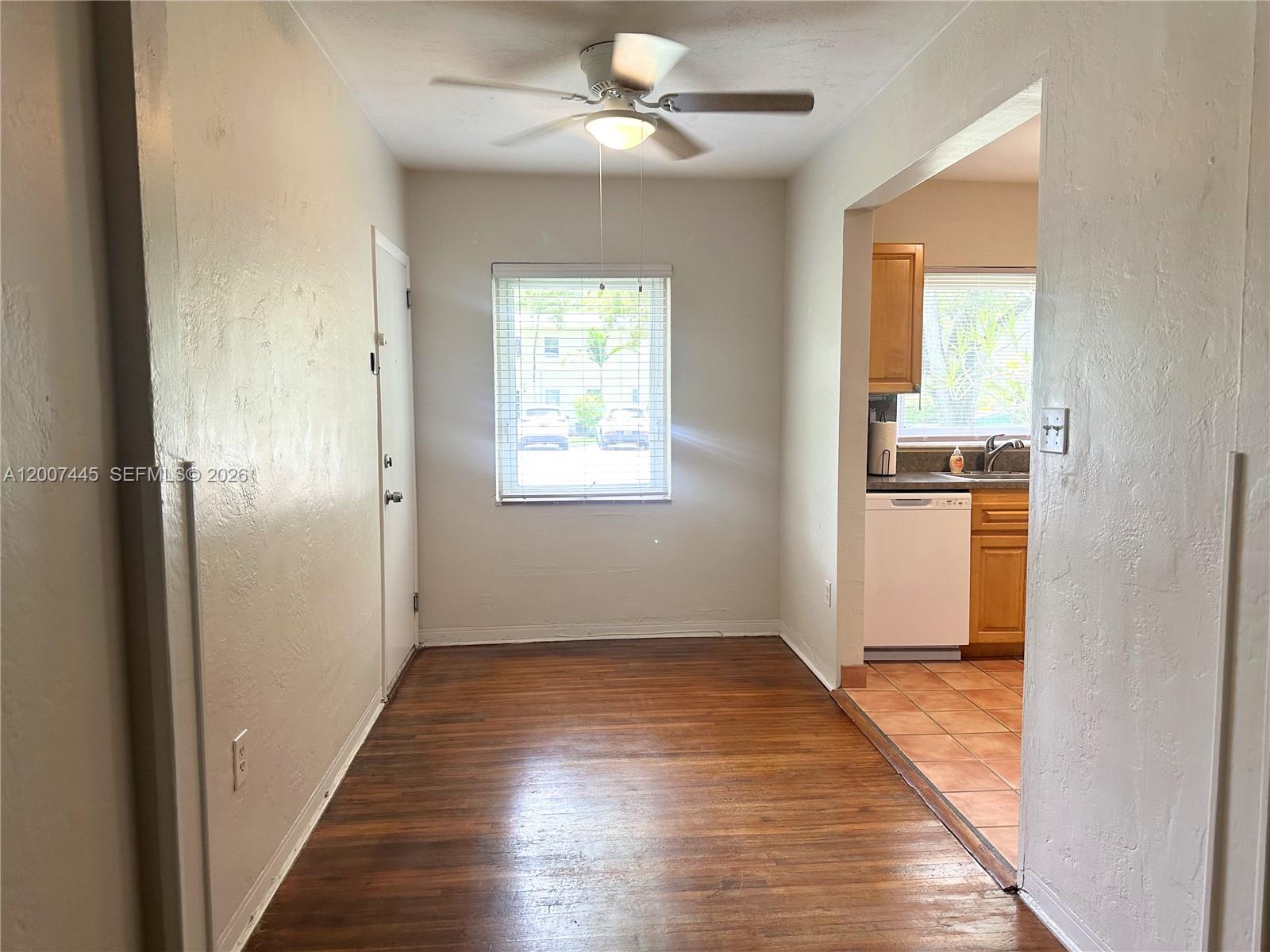 7734 Southwest 55th Avenue, Unit B Miami, FL 33143 - Photo 5 of 11 a view of empty room with wooden floor and fan