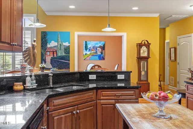 a kitchen with stainless steel appliances granite countertop a sink and a stove