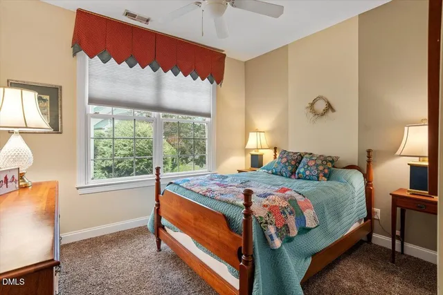 a bed sitting in a bedroom next to a window