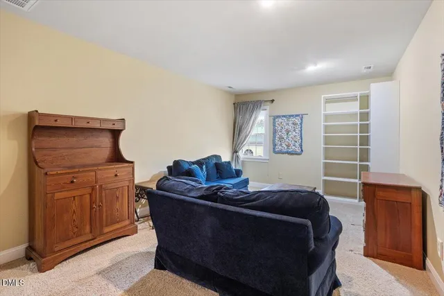 a living room with furniture and a closet