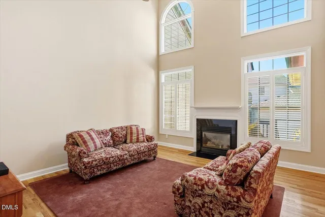 a living room with furniture fireplace and window