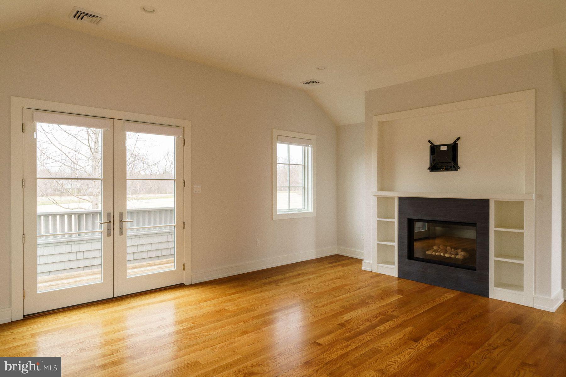 609 St Andrews Road Philadelphia, PA 19118 - Photo 30 of 43 a view of empty room with wooden floor and fireplace