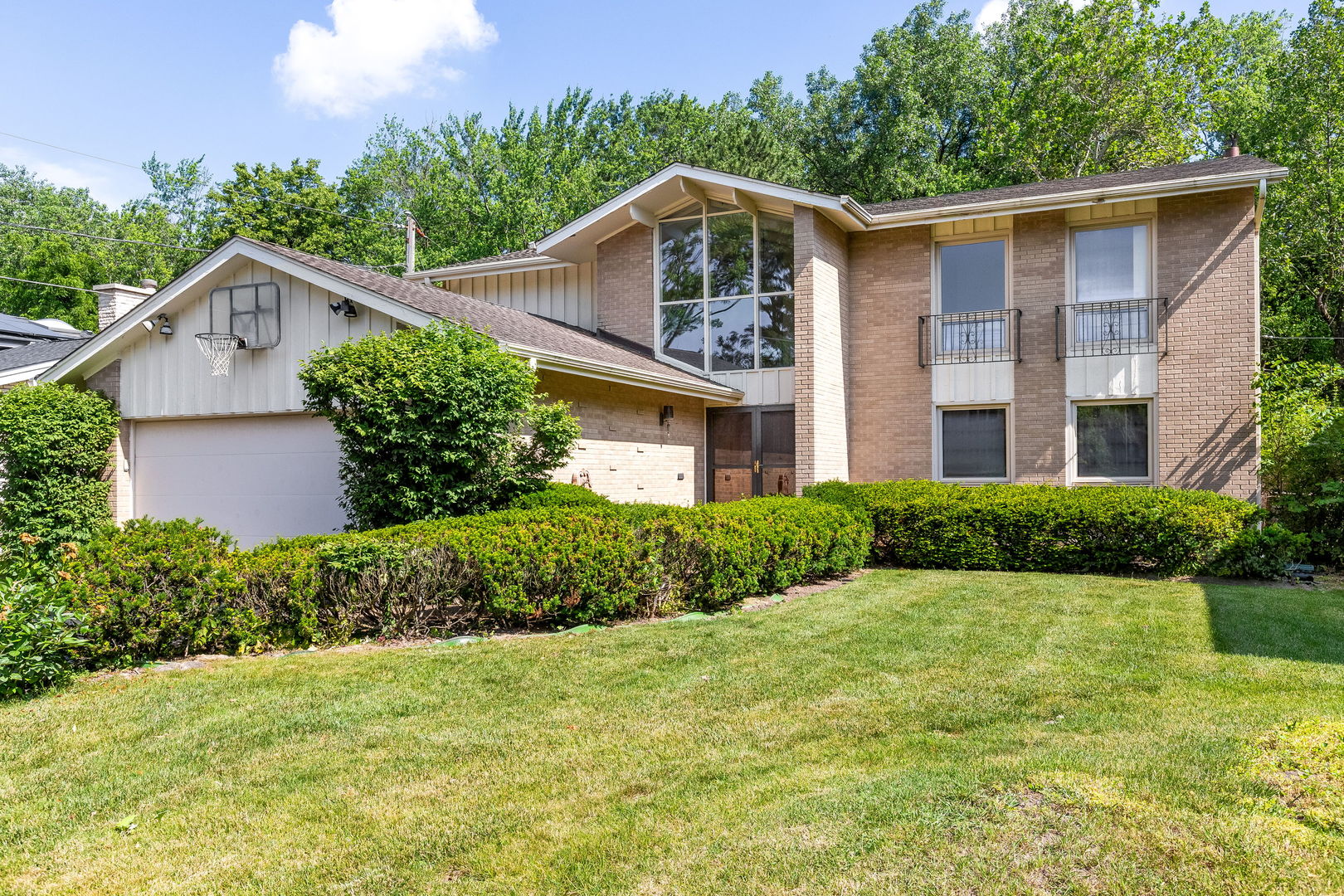 3528 Riverside Drive Wilmette, IL 60091 - Photo 1 of 33 a front view of a house with a yard and trees