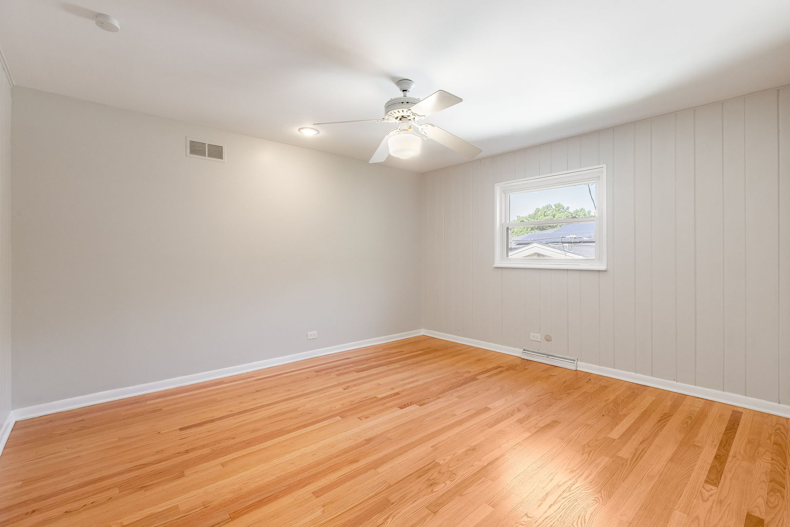 3528 Riverside Drive Wilmette, IL 60091 - Photo 19 of 33 an empty room with wooden floor ceiling fan and windows