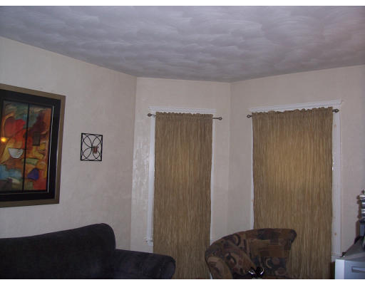 15 Fairmount Street Boston, MA 02124 - Photo 1 of 1 a bedroom with a bed and a painting on the wall