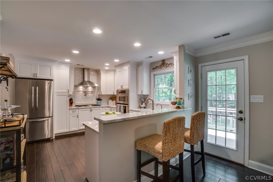 15209 Windy Ridge Road Midlothian, VA 23112 - Photo 13 of 40 a kitchen with refrigerator and cabinets