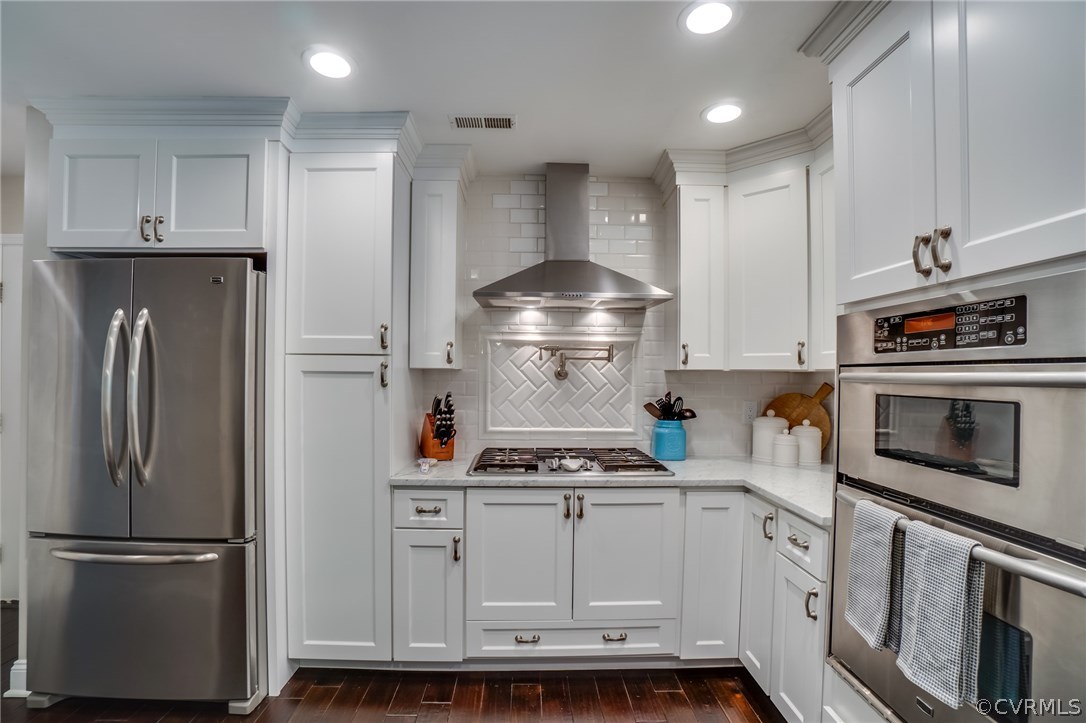 15209 Windy Ridge Road Midlothian, VA 23112 - Photo 15 of 40 a kitchen with stainless steel appliances granite countertop a refrigerator a stove a sink and a oven with wooden floor