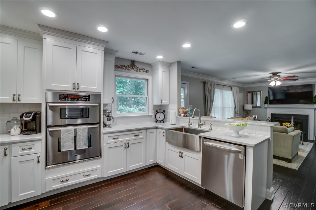 15209 Windy Ridge Road Midlothian, VA 23112 - Photo 17 of 40 a kitchen with a sink stove and cabinets