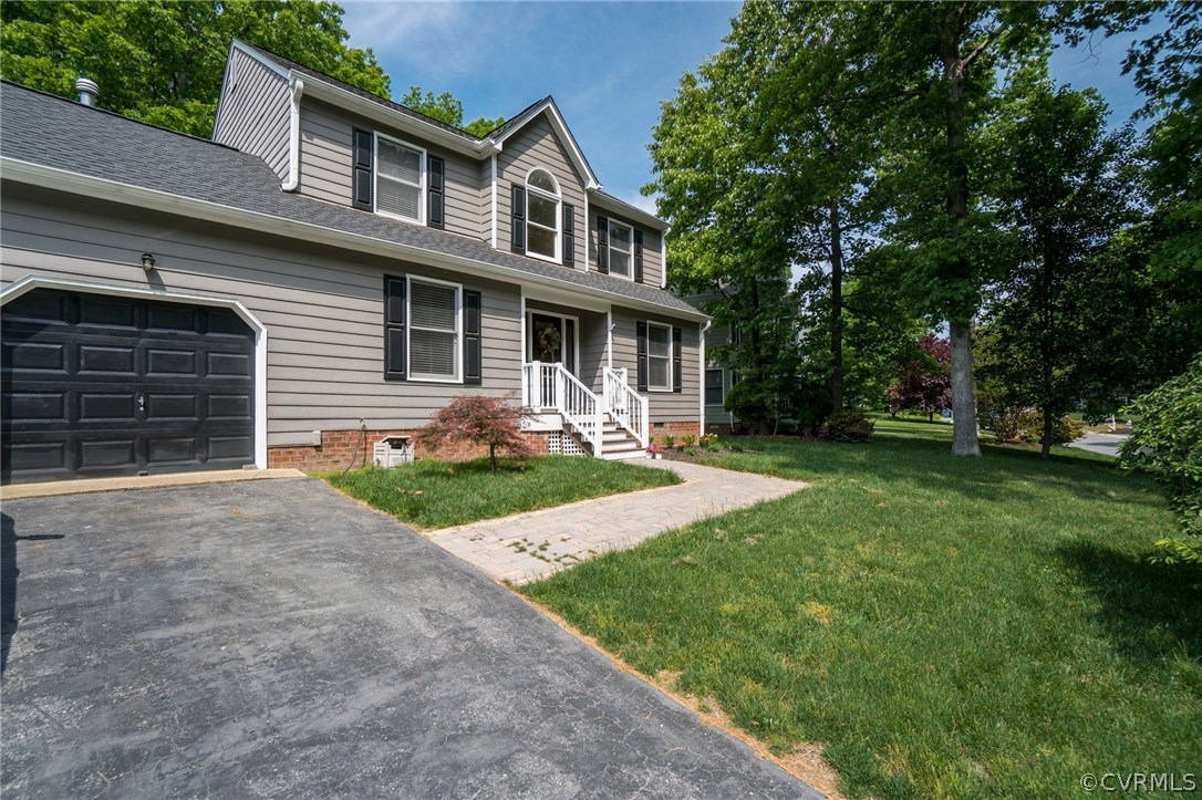 15209 Windy Ridge Road Midlothian, VA 23112 - Photo 2 of 40 a front view of a house with a yard and porch