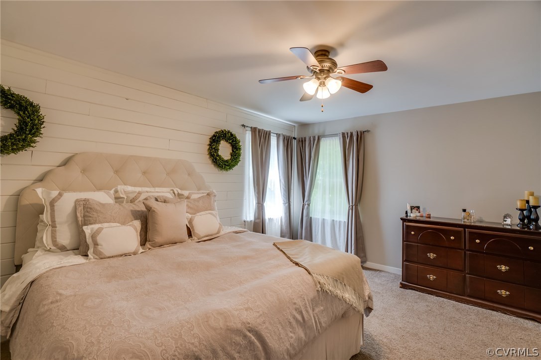 15209 Windy Ridge Road Midlothian, VA 23112 - Photo 24 of 40 a bedroom with a bed and a chandelier