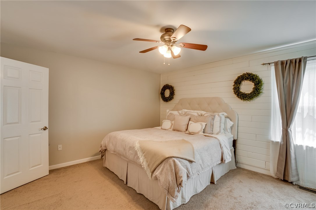 15209 Windy Ridge Road Midlothian, VA 23112 - Photo 26 of 40 a bedroom with a bed and a chandelier
