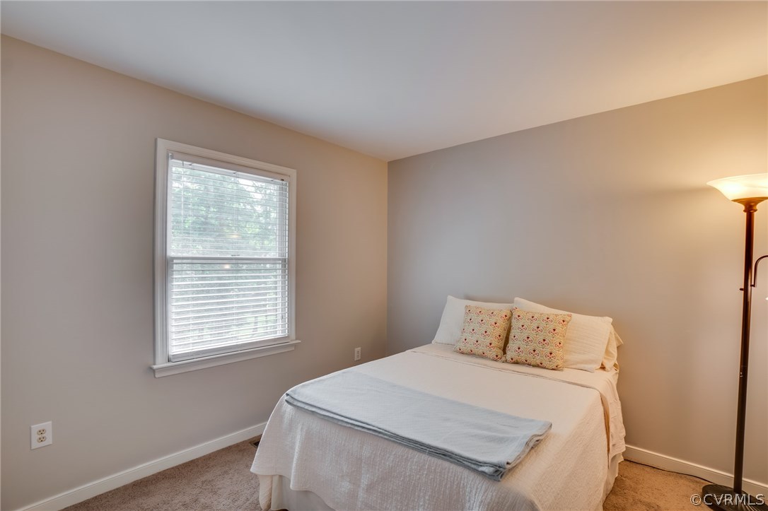 15209 Windy Ridge Road Midlothian, VA 23112 - Photo 28 of 40 a bedroom with a bed and a window