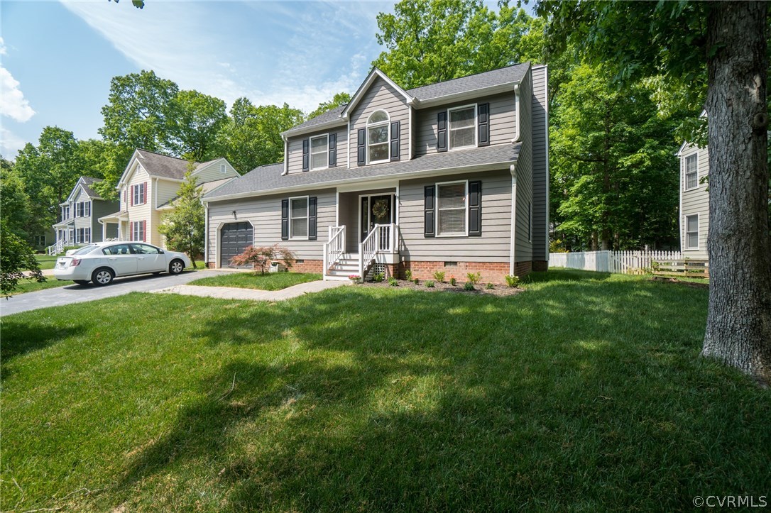 15209 Windy Ridge Road Midlothian, VA 23112 - Photo 3 of 40 a front view of a house with a yard table and chairs