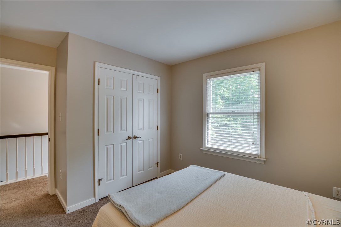 15209 Windy Ridge Road Midlothian, VA 23112 - Photo 31 of 40 a bedroom with a bed and a window