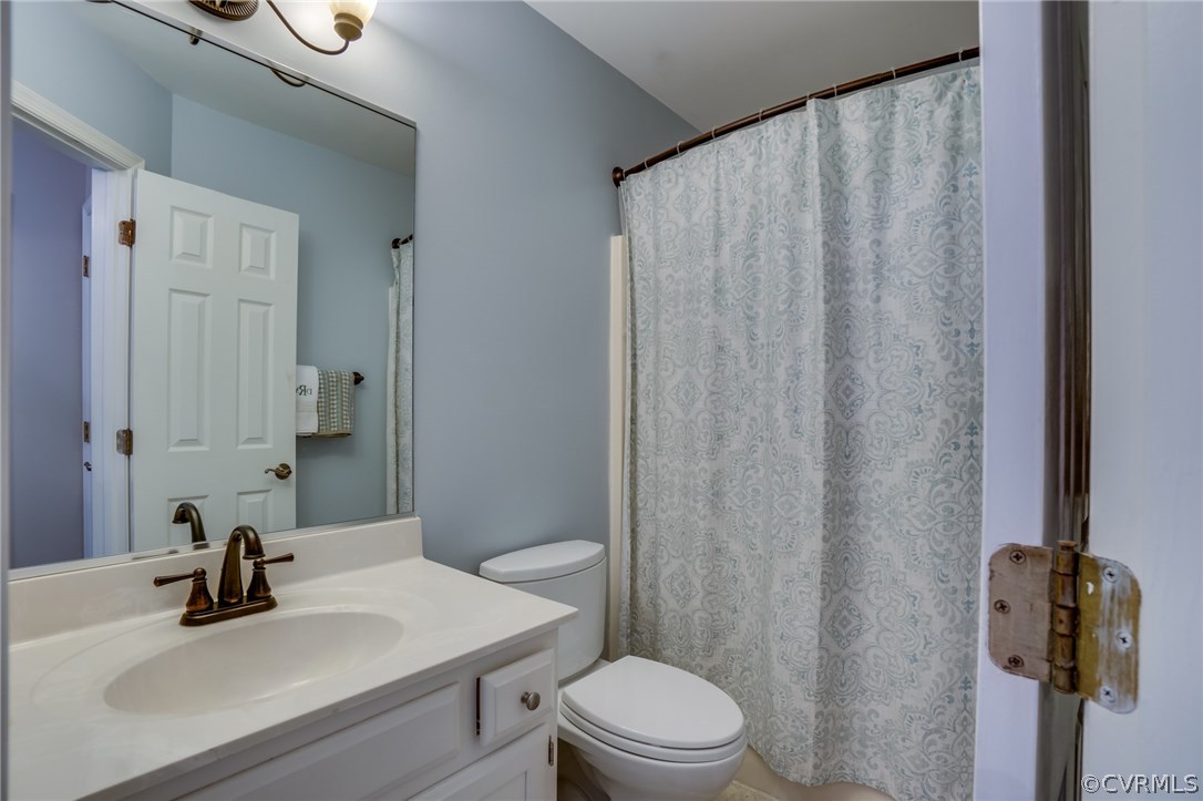15209 Windy Ridge Road Midlothian, VA 23112 - Photo 32 of 40 a bathroom with a sink a toilet and shower