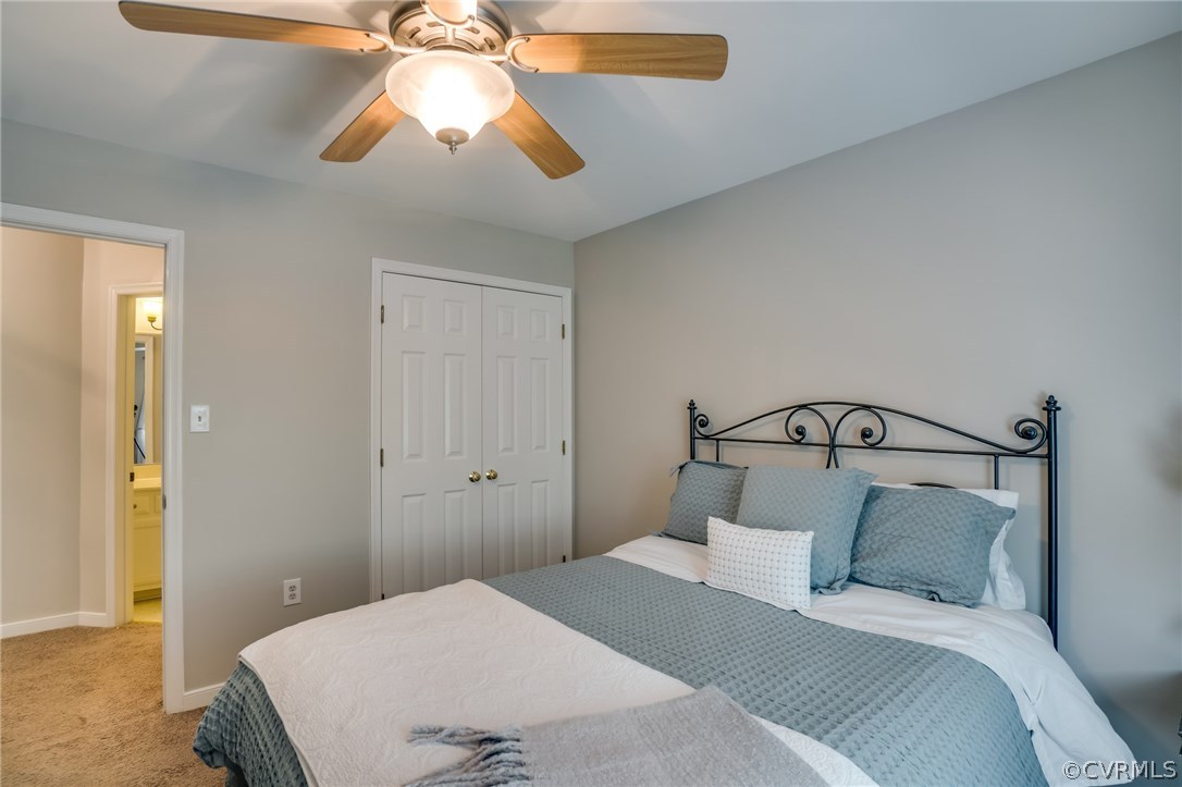 15209 Windy Ridge Road Midlothian, VA 23112 - Photo 34 of 40 a bedroom with a bed and a chandelier