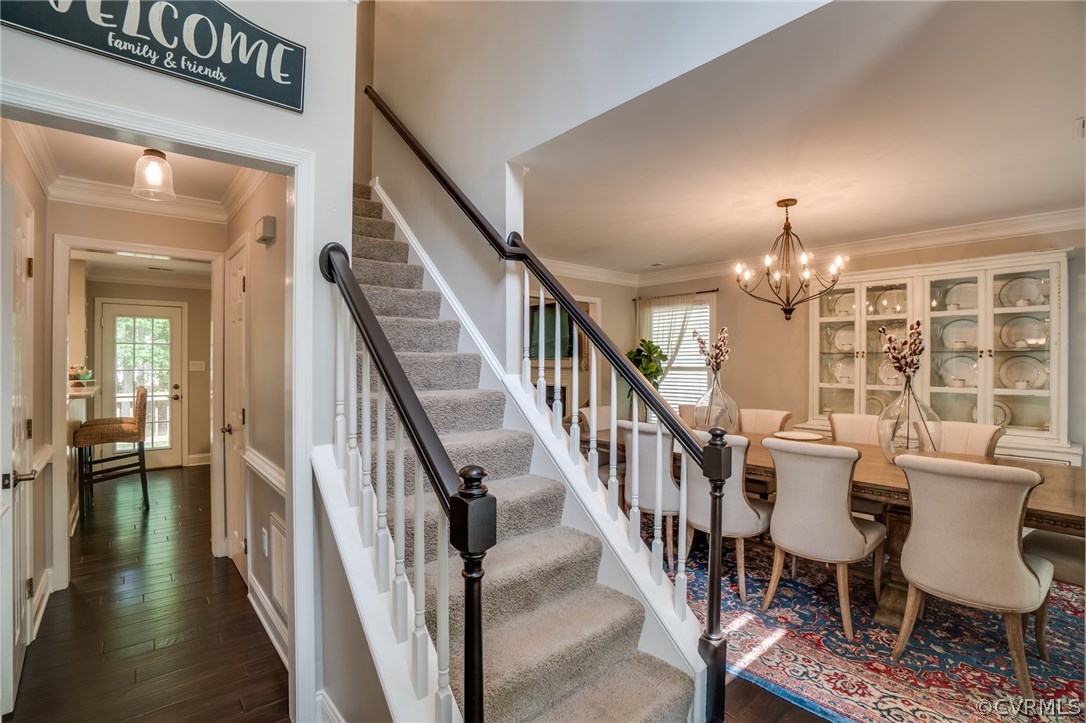 15209 Windy Ridge Road Midlothian, VA 23112 - Photo 5 of 40 a view of a livingroom with furniture stairs wooden floor and a chandelier