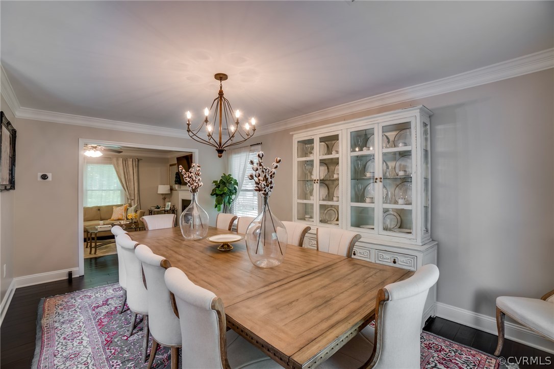 15209 Windy Ridge Road Midlothian, VA 23112 - Photo 7 of 40 a dining room with a table or chairs and a dining table with wooden floor