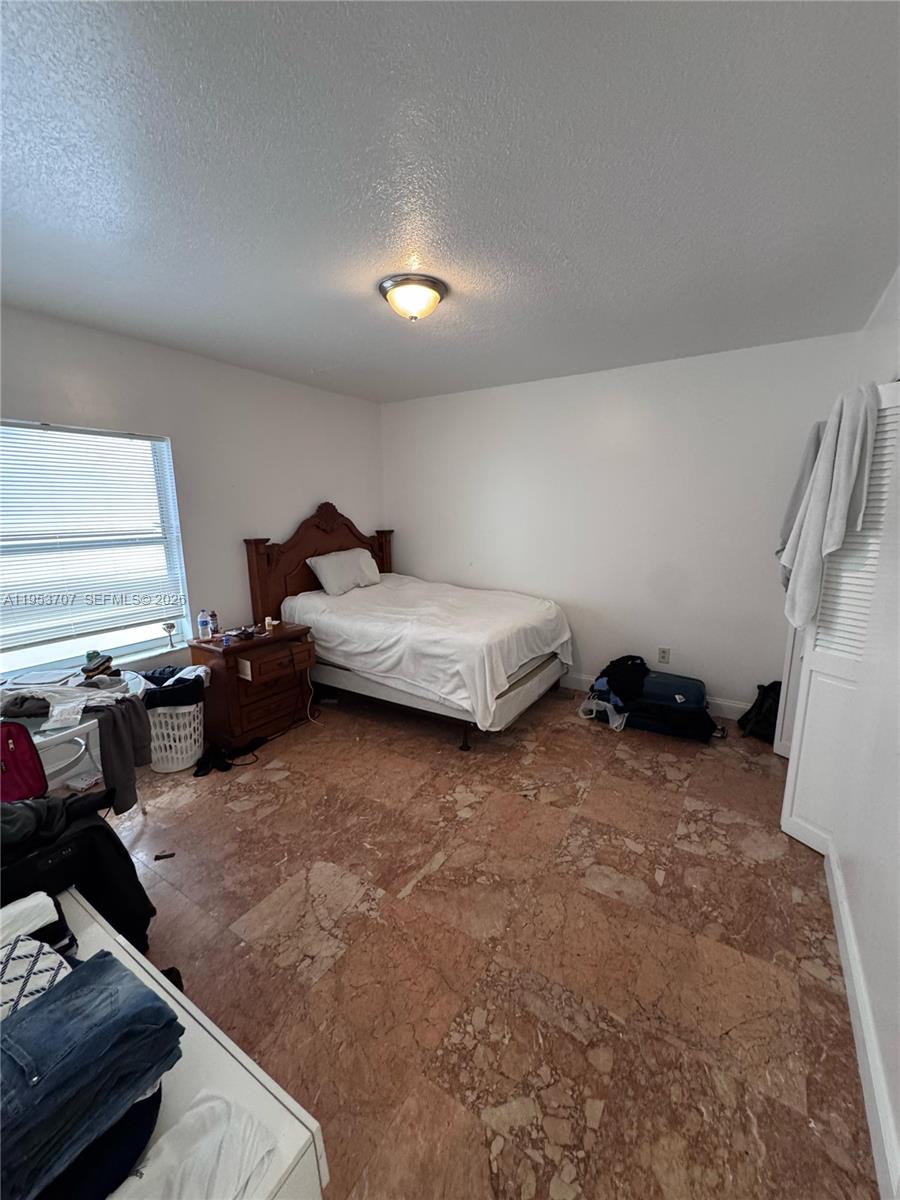 Surfside Surfside, FL 33154 - Photo 4 of 11 a bedroom with furniture and a couch