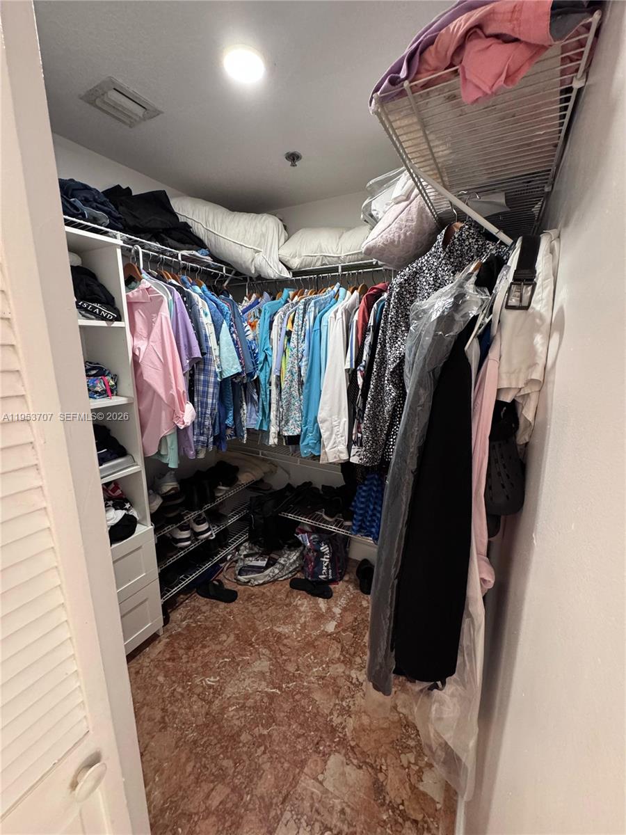 Surfside Surfside, FL 33154 - Photo 8 of 11 a view of walk in closet with clothes and shoes