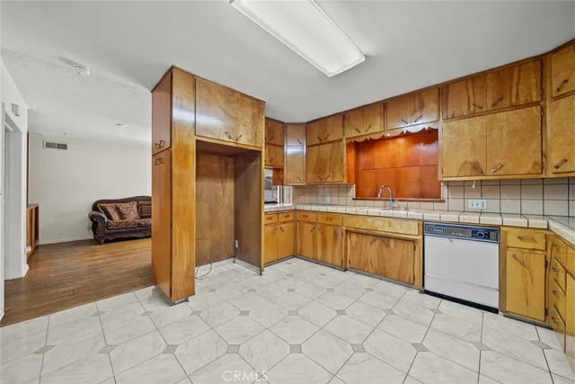 a kitchen with stainless steel appliances granite countertop a sink and cabinets