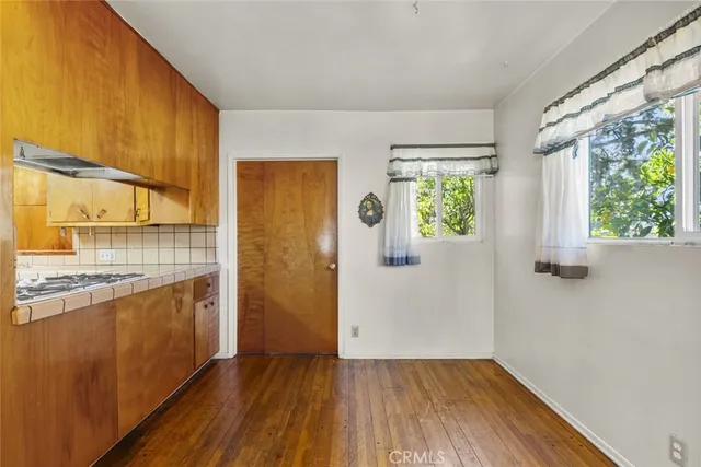 a view of a kitchen with wooden floor and a sink