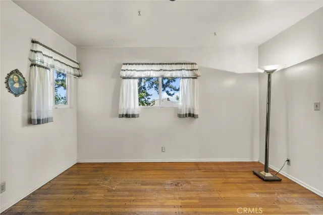 a view of empty room with window and fan