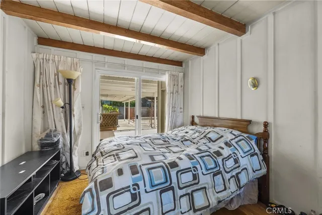 a bed sitting in a bedroom next to a window