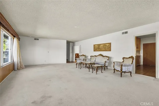 a view of a livingroom with furniture and a window