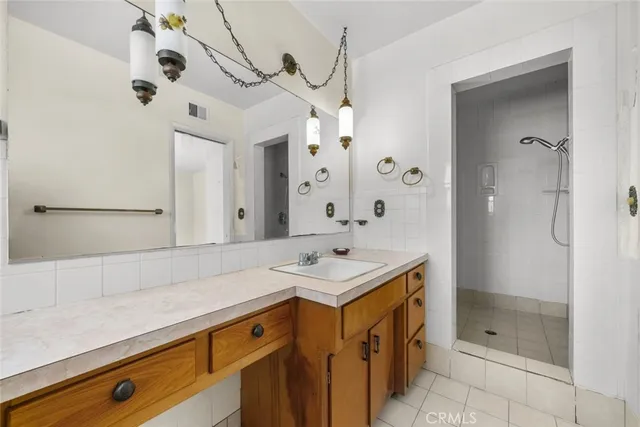 a bathroom with a sink a mirror and shower