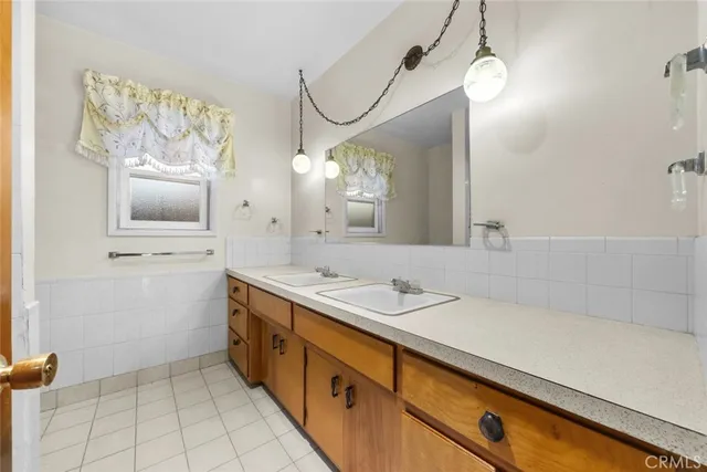 a spacious bathroom with a double vanity sink mirror and bathtub