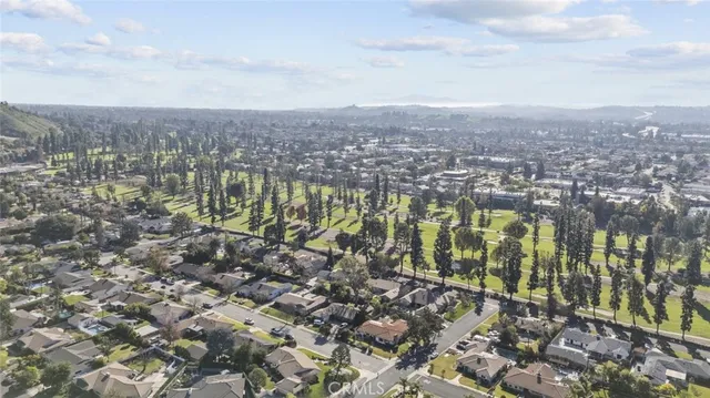 an aerial view of residential building with green space