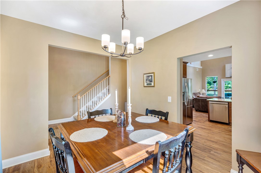 3004 Cobbs Way Anderson, SC 29621 - Photo 6 of 46 An open doorway connects the dining area to adjacent living spaces over wood flooring.