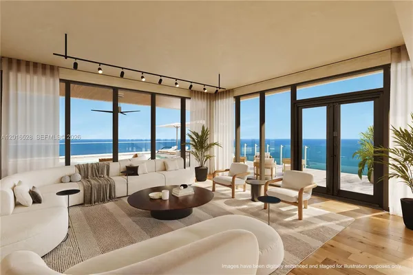 a living room with furniture and floor to ceiling windows